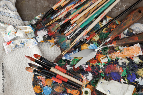 Brushes and paints for painting on an old background.