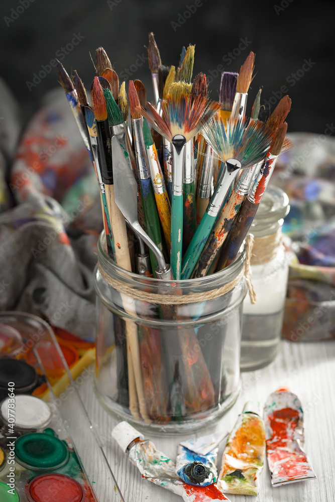 Multi-colored oil paints squeezed out of a tube onto a white sheet of paper. Multi-colored oil paints squeezed out of a tube onto a white sheet of paper.