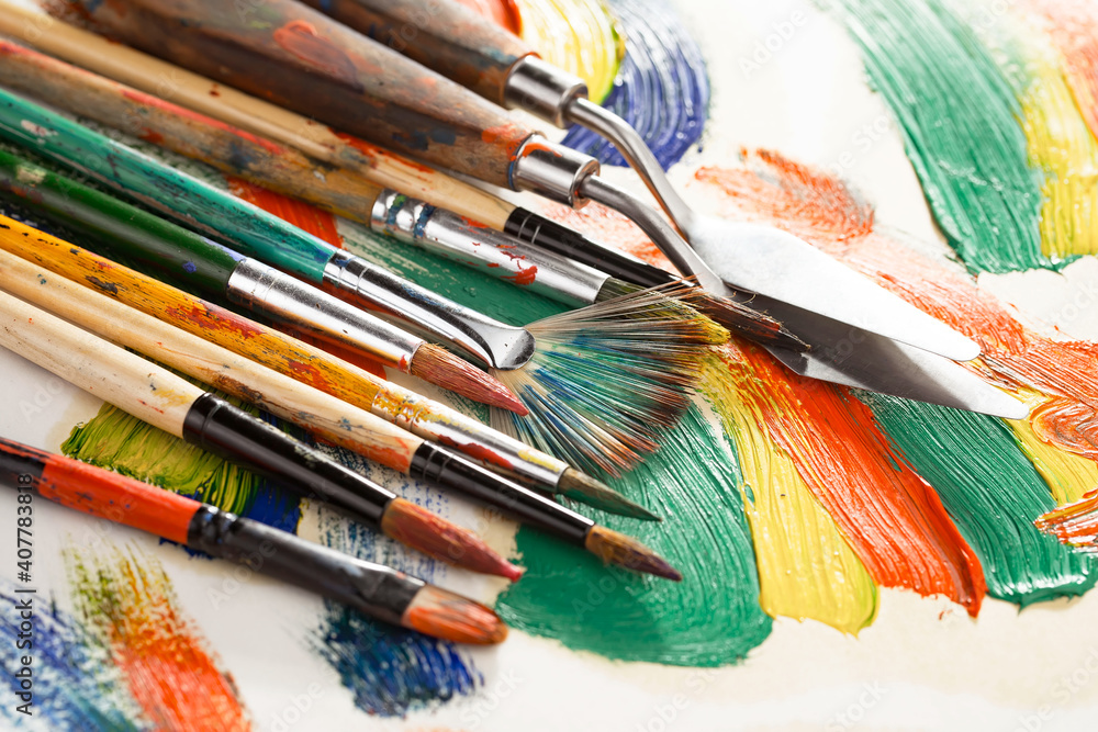 Brushes and paints for painting on an old background.