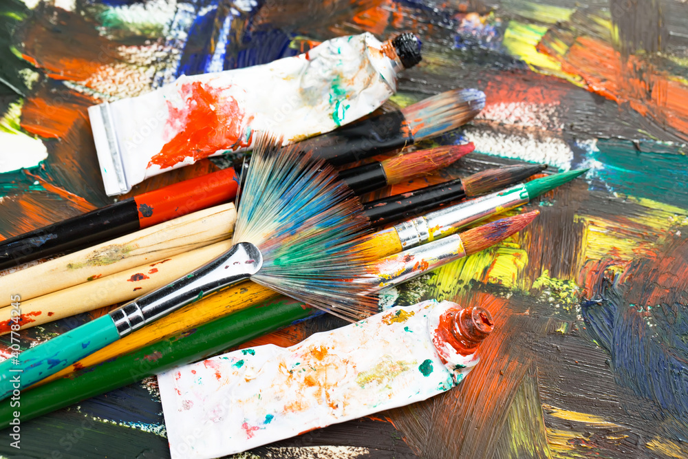 Obraz premium Multi-colored oil paints squeezed out of a tube onto a white sheet of paper.