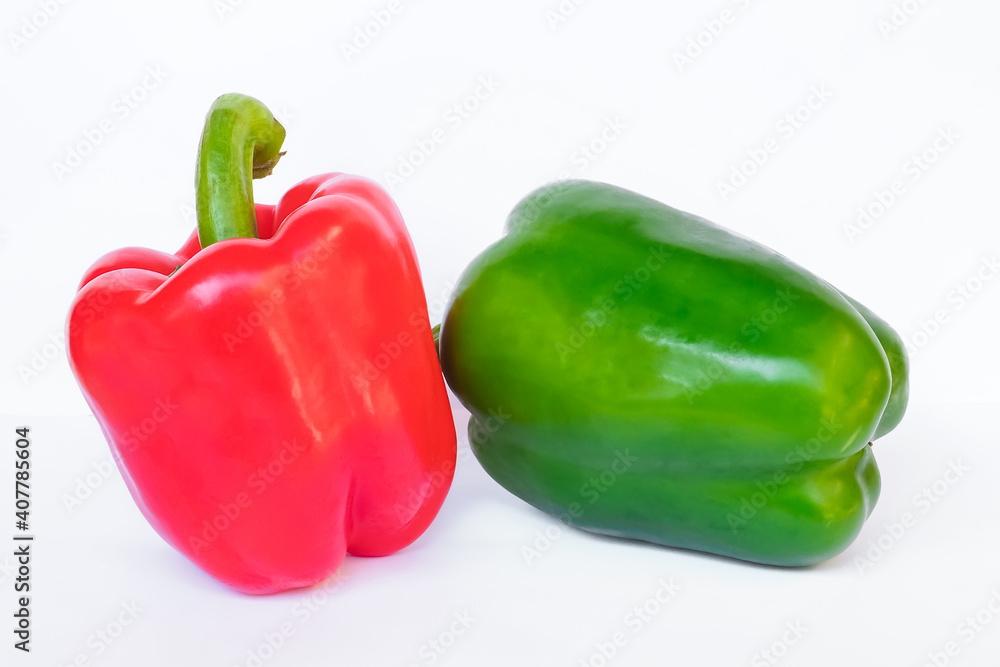 Red, green sweet pepper on a white background. Close up view. Red, green sweet pepper on a white background. Close up view.