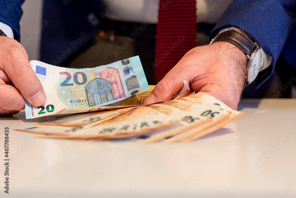 Business man showing in hand fifty and twenty euro banknote. Financial and money saving concept Business man showing in hand fifty and twenty euro banknote. Financial and money saving concept