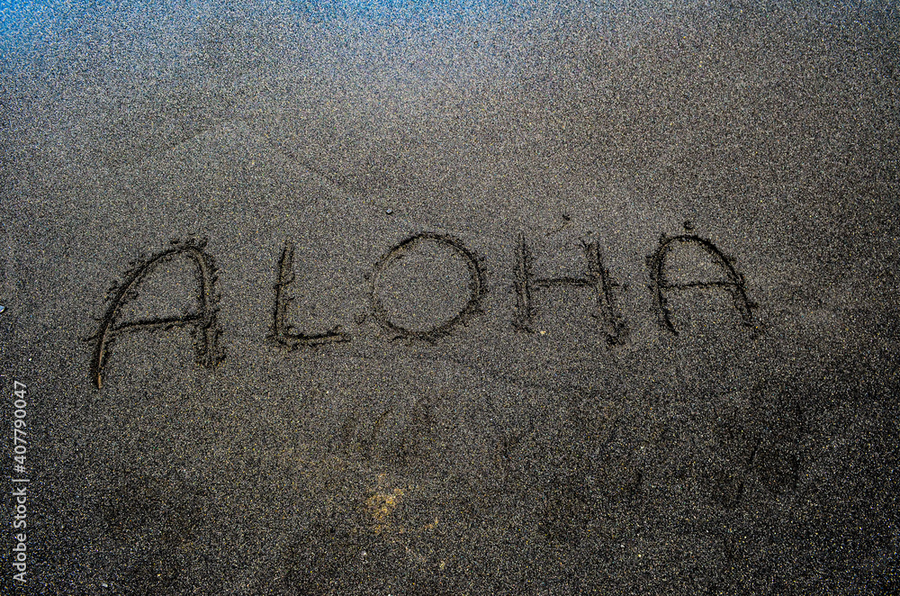Fototapeta premium The word Aloha, written into the black sandy beach on the Big Island of Hawaii