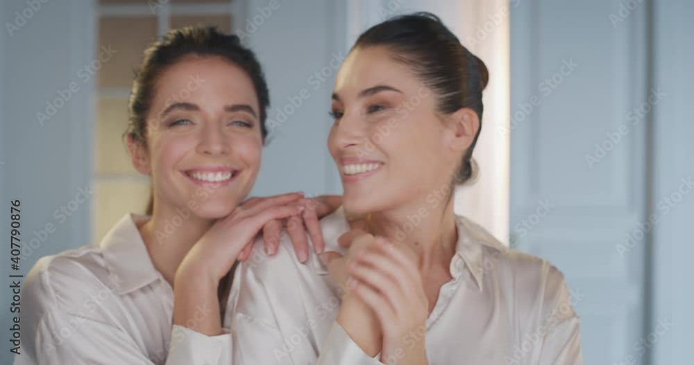 Cinematic shot of happy mature mother and young adult daughter full of positive emotions embracing and laughing together in camera at home. Concept: family,motherhood, femininity,love,generation,women Cinematic shot of happy mature mother and young adult daughter full of positive emotions embracing and laughing together in camera at home. Concept: family,motherhood, femininity,love,generation,women
