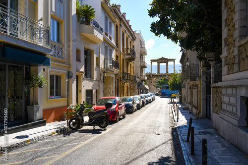 Fototapeta Naklejka Na Ścianę i Meble -  View from a quiet street as traffic passes by The Arch of Hadrian, known in Greek as Hadrian's Gate in the historic center of Athens, Greece