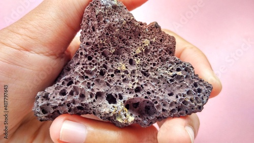 specimen Scoria igneous rock, black and brownish red color from the central java volcano, Indonesia. Basaltic lava, oxidation of iron during eruptions. Rocks and minerals identification 