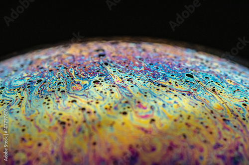 Detailed macro shot of a soap bubble - abstract and colorful pattern