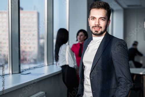 Portrait of a young businessman wearing in networking office.