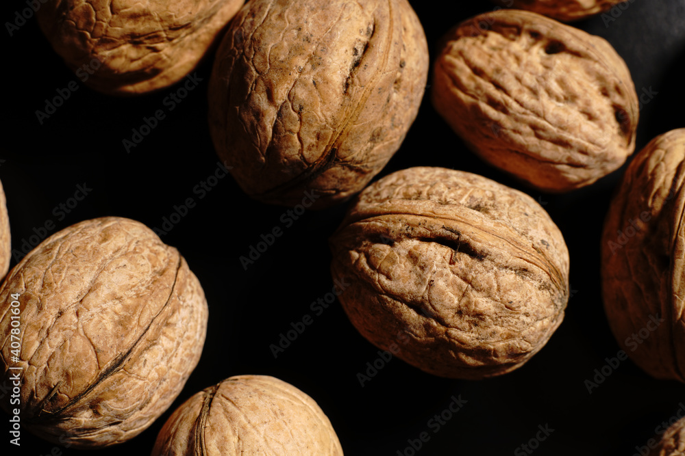 Walnuts on a black background. The light was dim. Walnuts on a black background. The light was dim.