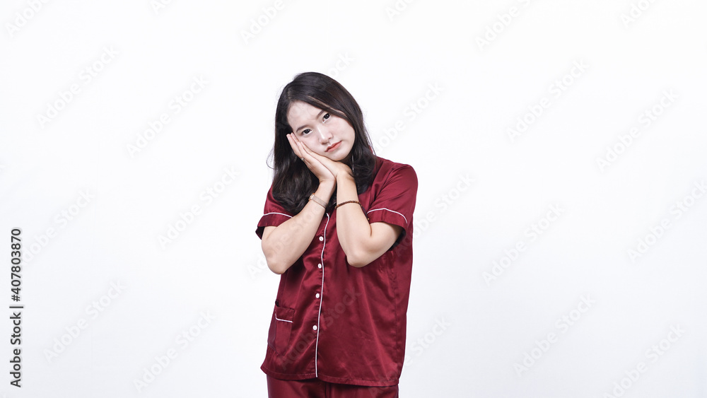 Young asian woman wearing pajama and started to sleep isolated white background Young asian woman wearing pajama and started to sleep isolated white background