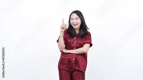 Asian woman wearing pajama thinking and get idea isolated white backiground photo