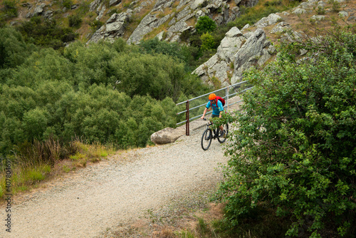A young man cycling the Otago Central Rail Trail on the Poolburn Viaduct, South Island, New Zealand