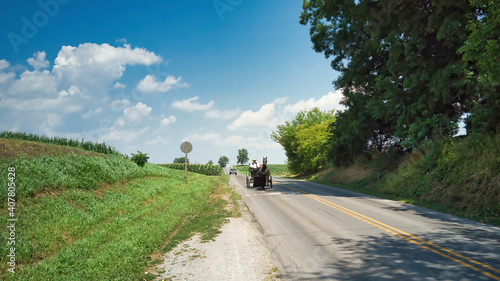 An Amish Horse and Open Buggy With an Amish Man in It