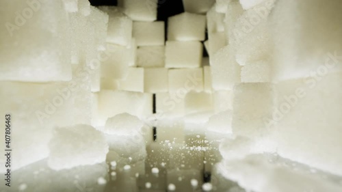 A large pile of beautiful white food sugar on a dark background.