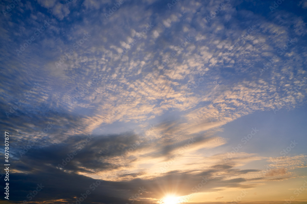Sunrise skyline with blue sky and sun rays pass from cloud