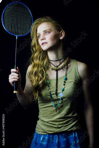 young ginger woman with Badminton Racket. Fasfion style photo