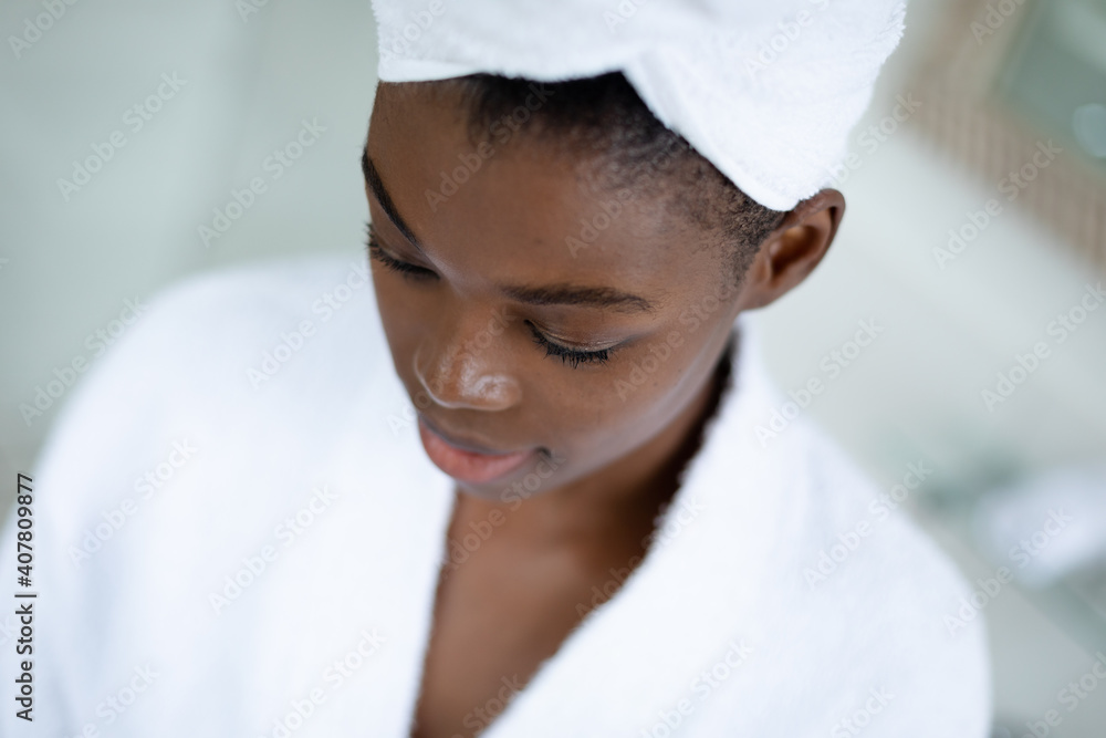 Close up view of african american woman in bathrobe in bathroom at home Close up view of african american woman in bathrobe in bathroom at home