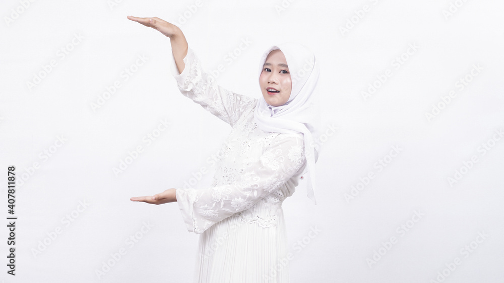 Asian muslim woman wearing prayer beads opinting tio blank space in white background Asian muslim woman wearing prayer beads opinting tio blank space in white background
