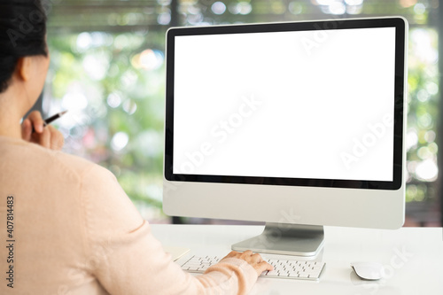 women using computer working at home with blank white desktop screen.