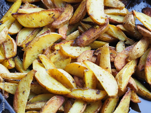 potato slices baked in butter with oregano turmeric and curry