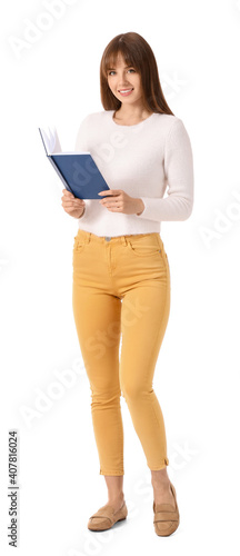 Beautiful young woman with book on white background