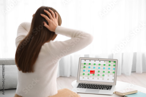 Stressed young woman trying to meet deadline at home