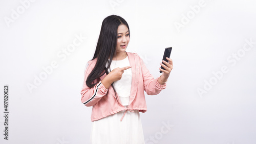 Portrait of Asian woman pointing her smart phone isolated white background