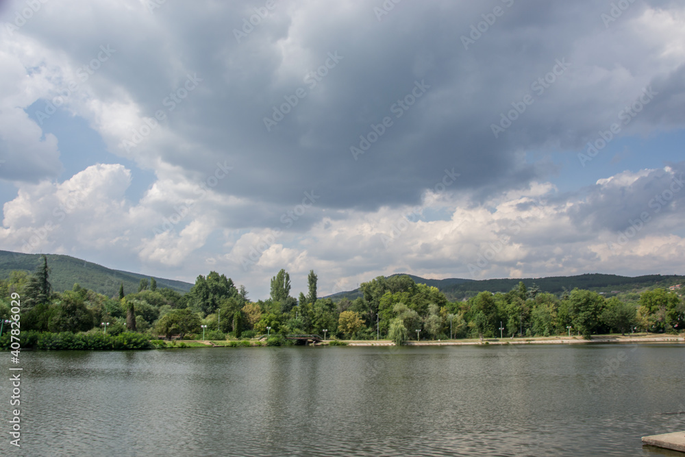 Beautiful peaceful nature, trees and plants on a lake, park, summertime season, reflection in the water, Zagorka lake, Stara Zagora, Bulgaria