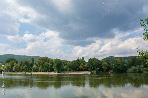 Beautiful peaceful nature, trees and plants on a lake, park, summertime season, reflection in the water, Zagorka lake, Stara Zagora, Bulgaria © Len0r