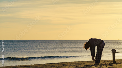 Woman exercising on beach at morning.