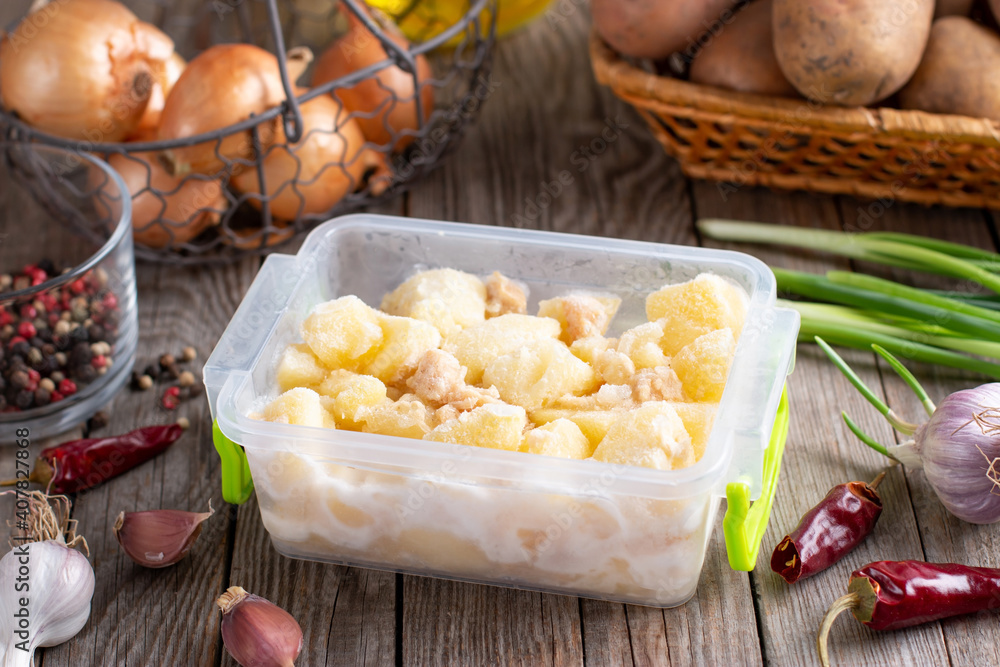 Stewed potatoes with meat in a container. Ready meals. Frozen food. Saving time and effort for cooking