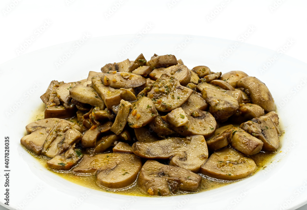 Fried mushrooms, Funghi trifolati, in a white dish isolated on white background Fried mushrooms, Funghi trifolati, in a white dish isolated on white background