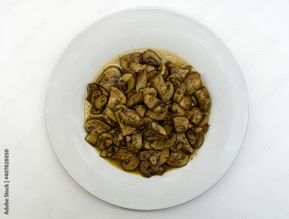 Fried mushrooms, Funghi trifolati, in a white dish isolated on white background Fried mushrooms, Funghi trifolati, in a white dish isolated on white background