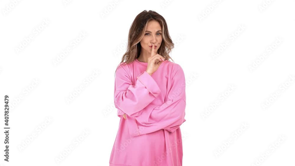 Beautiful woman showing sign silent with forefinger near mouth. Shot on RED Raven 4k Cinema Camera Beautiful woman showing sign silent with forefinger near mouth. Shot on RED Raven 4k Cinema Camera