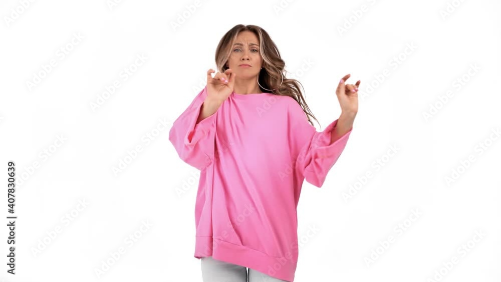 Joyful woman dancer in pink pullover performing funky movement isolated. Shot with RED camera in 4K