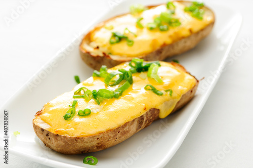 baked potatoes smothered with aged cheddar chees