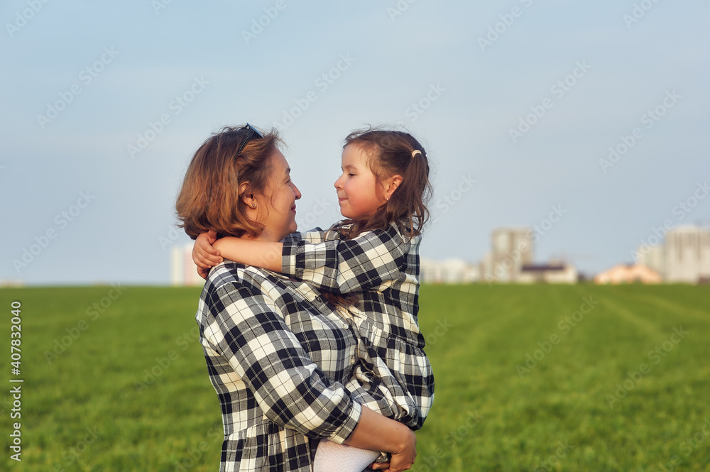 Happy mother and daughter on a country walk . Happy mother and daughter on a country walk .