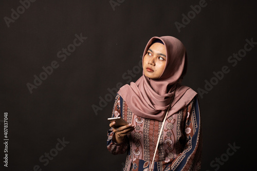 Fashion portrait of young beautiful asian muslim woman with wearing hijab on black background