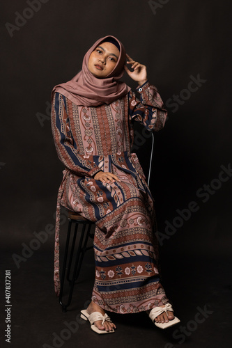 Fashion portrait of young beautiful asian muslim woman with wearing hijab on black background