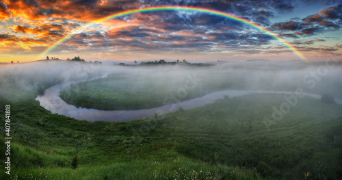 Landscape with a Rainbow on the River in Spring. colorful morning