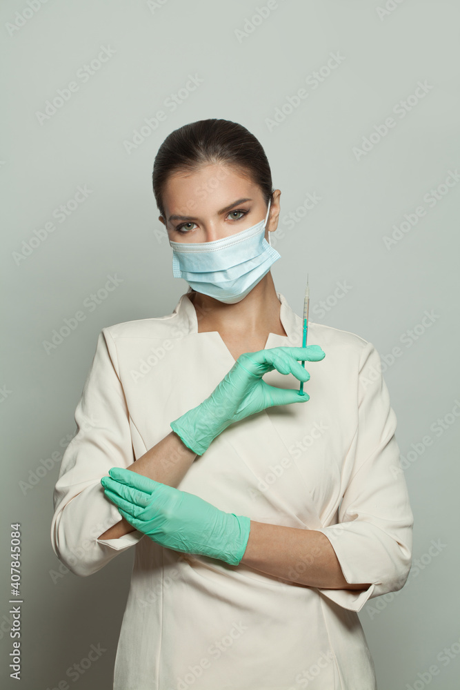 Physician or nurse holding syringe and ampoule injecting on white background. Medicine, cosmetology and vaccination concept Physician or nurse holding syringe and ampoule injecting on white background. Medicine, cosmetology and vaccination concept