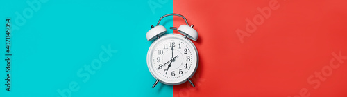 Banner white clock alarm in vintage style on red green background with place for text