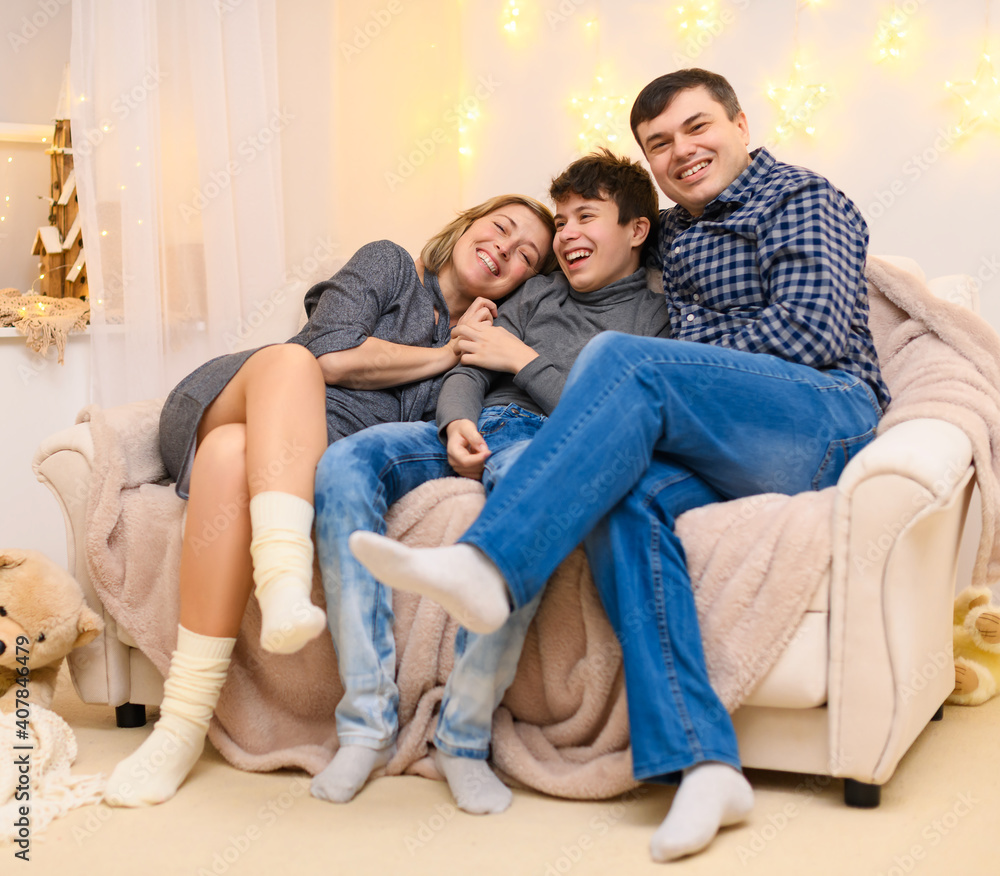portrait of a family sitting on a sofa at home portrait of a family sitting on a sofa at home