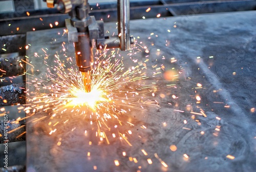 Cutting machine is starting to cut thick steel. Sparks and heat.