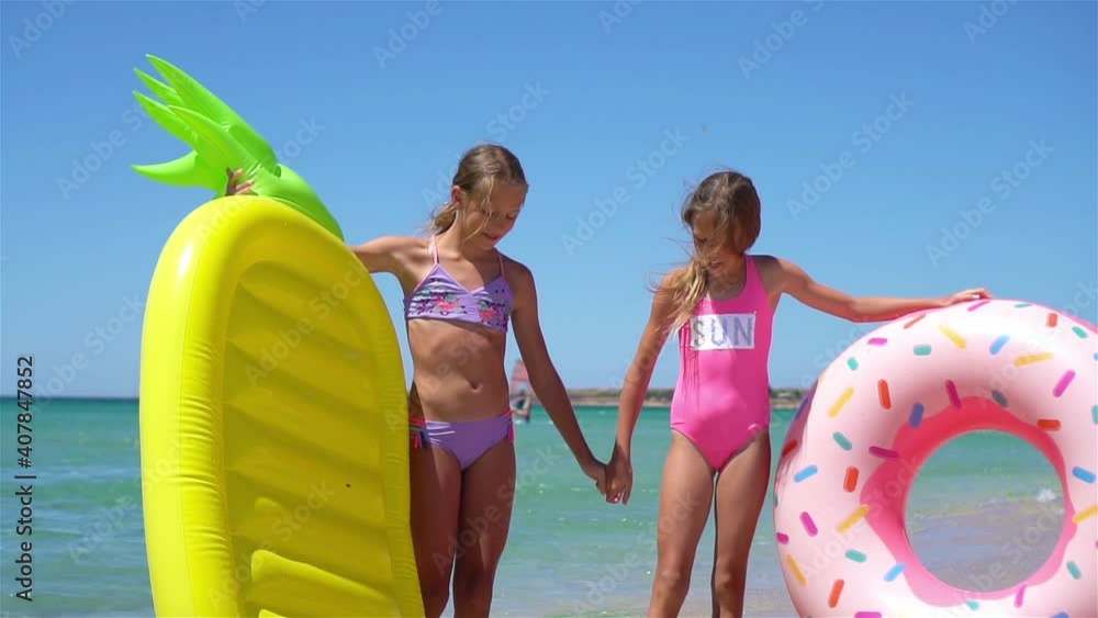 Adorable little girls having fun on the beach Stock Video