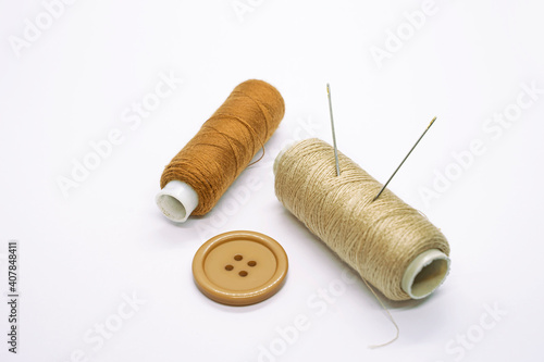 Sewing accessories. Threads, needles, tape measure, buttons, pins. Close-up. White background. Hobby. Needlework. Sewing