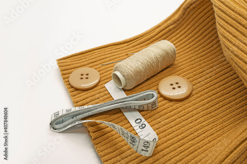 Sewing accessories. Threads, needles, tape measure, buttons, pins. Close-up. White background. Hobby. Needlework. Sewing