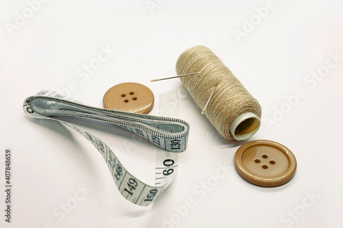 Sewing accessories. Threads, needles, tape measure, buttons, pins. Close-up. White background. Hobby. Needlework. Sewing