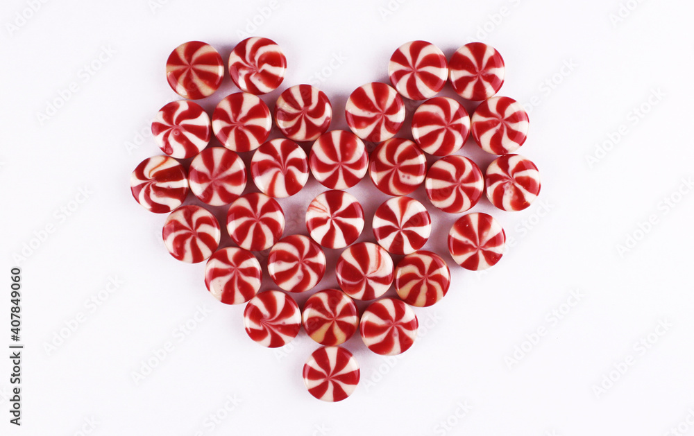 Heart shape made from round lollipops. Sweet heart for valentine's day on white background