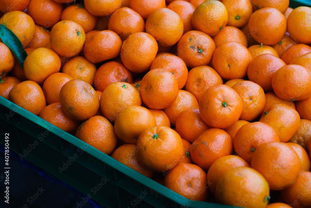 Orange tangerines in a green chest.